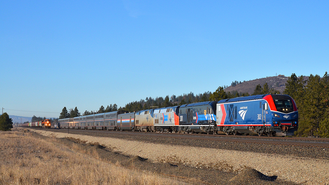 First run: Amtrak no. 8, the eastbound Empire Builder, overtakes a BNSF empty grain train at Moab, Wash. Bruce Kelly photo