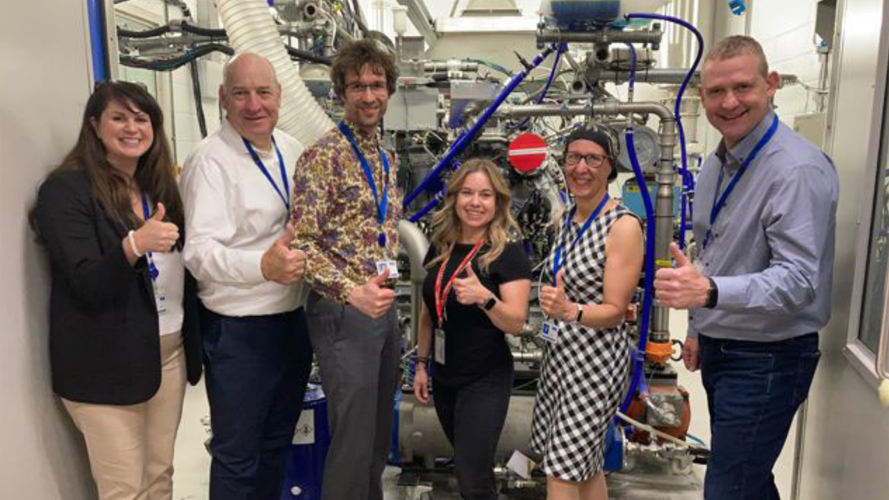 Kari Gonzales of MxV Rail (center) and members of the Ricardo team visit the H2ICE test cell at Ricardo’s Shoreham Technical Center. (Caption and Photograph Courtesy of Ricardo)
