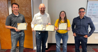 Team members (from left to right) Martin Ertz, Josh Saltz and Jessica Codr accept their awards for the Hack! 2022 event from UP Senior Vice President and CIO Rahul Jalali. (Photo Courtesy of UP via Twitter)
