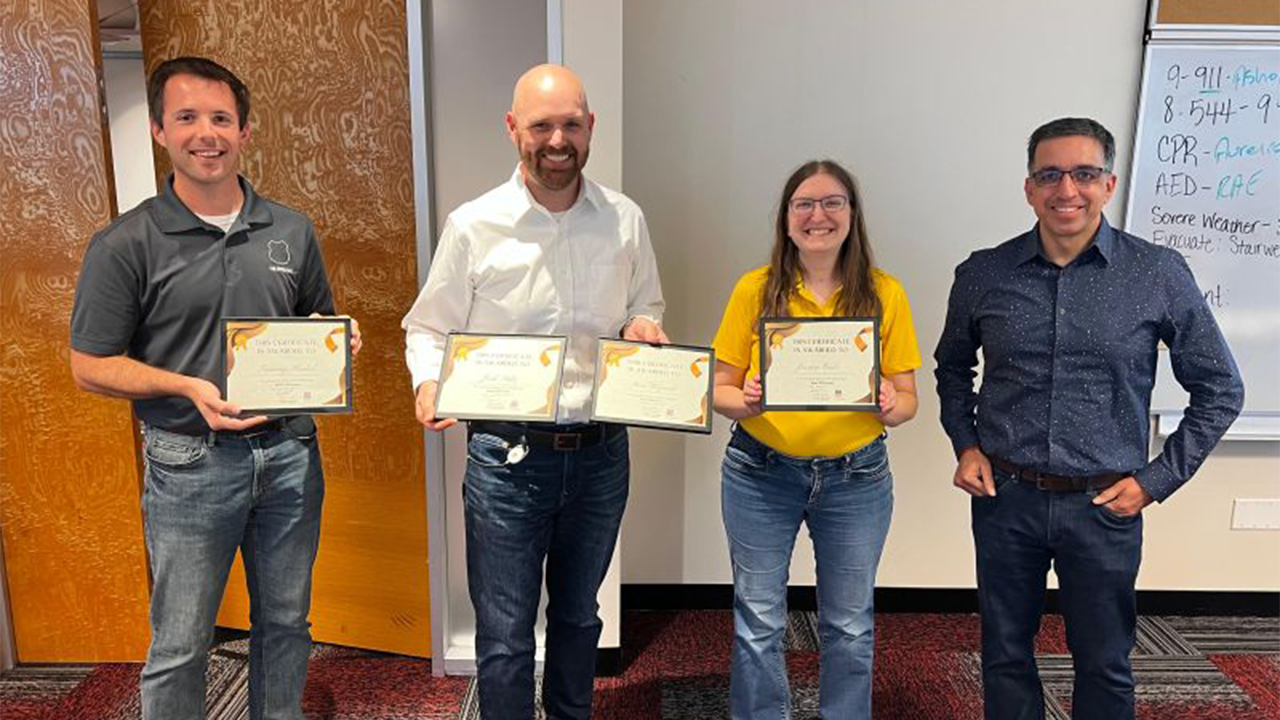 Team members (from left to right) Martin Ertz, Josh Saltz and Jessica Codr accept their awards for the Hack! 2022 event from UP Senior Vice President and CIO Rahul Jalali. (Photo Courtesy of UP via Twitter)
