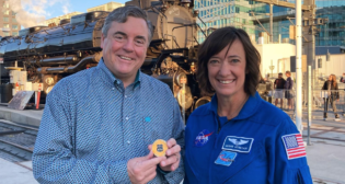 Astronaut Megan McArthur Behnken (right) returns the Big Boy locomotive challenge coin that she brought into space to Scott Moore, Union Pacific Senior Vice President-Corporate Relations and Chief Administrative Officer (left). (Caption and Photograph Courtesy of UP)