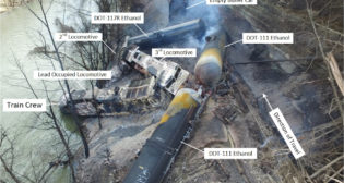 Aerial view of the derailment scene.​​ (Photograph courtesy of Pike County Office of Emergency Management with overlay annotations by NTSB.)