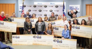 Representatives from OmniTRAX and The Brownsville & Rio Grande International Railway host the local nonprofit recipients of their annual community outreach program. $100,000 in donations were distributed to eleven local nonprofits throughout the Brownsville community.