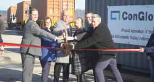 Cutting the celebratory ribbon at Millersburg are, from left, ConGlobal CEO Brandt Ring, Governor Kate Brown, Linn County Commissioner and Board Vice Chair for the Linn County Economic Development Group Roger Nyquist, Julie Brown, ODOT Director Kris Strickler Kris Strickler and UP Senior Director of Public Affairs Aaron Hunt Aaron Hunt.