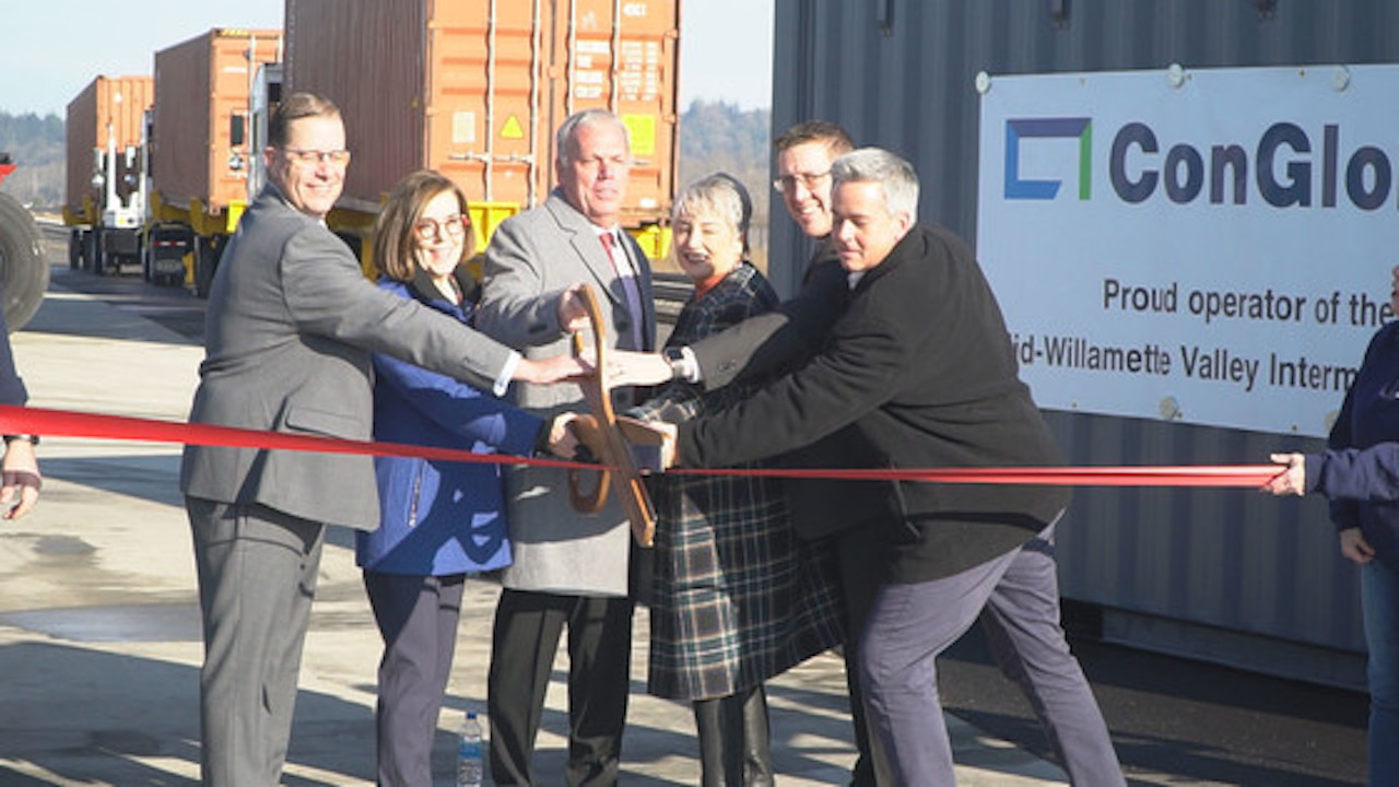 Cutting the celebratory ribbon at Millersburg are, from left, ConGlobal CEO Brandt Ring, Governor Kate Brown, Linn County Commissioner and Board Vice Chair for the Linn County Economic Development Group Roger Nyquist, Julie Brown, ODOT Director Kris Strickler Kris Strickler and UP Senior Director of Public Affairs Aaron Hunt Aaron Hunt.