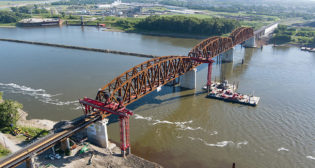 The 133-year-old Merchants Bridge, which spans the Mississippi River at St. Louis and links Missouri and Illinois, officially reopened to rail traffic Sept. 15, following completion of a $222 million replacement project. Owned and operated by the Terminal Railroad Association (TRRA), the bridge serves six Class I railroads and Amtrak. (Courtesy Walsh Construction and Trey Cambern Photography)