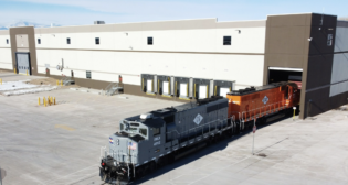 Broe Real Estate Group’s flatbed distribution center for The Home Depot (pictured) has been recognized as NAIOP’s 2022 Industrial Development of the Year. It is served by OmniTRAX’s Great Western Railway of Colorado. Broe Real Estate Group and OmniTRAX are affiliates of The Broe Group. (Photograph Courtesy of OmniTRAX)