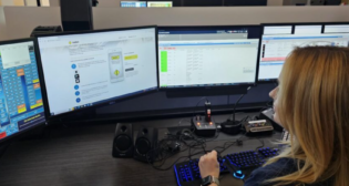 Sumner County Tennessee Emergency Communications Training Officer Brooke Elkins learns about AskRail. (Caption and Photograph Courtesy of AAR)