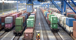 Rail-mounted gantry cranes work trains at the Port of Savannah’s Mason Mega Rail Terminal. Containers moving by rail from Savannah to the planned Northeast Georgia Inland Port in Gainesville, Ga., will avoid a round-trip truck route of 602 miles on Georgia highways. [Photo:Georgia Ports Authority / Stephen Morton]
