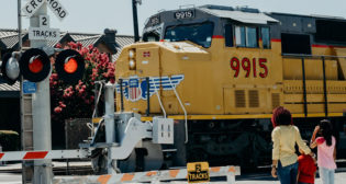 Only cross train tracks at a designated crossing. Designated crossings are marked by a sign, lights, or a gate. (Safe Kids Worldwide photo)