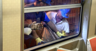 Crews replace windows broken by vandals on Sept. 12. (Marc Hermann / MTA)