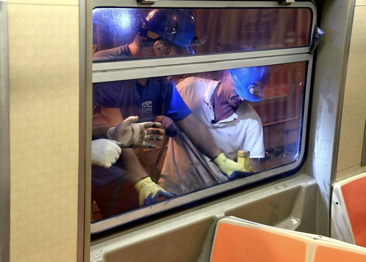 Crews replace windows broken by vandals on Sept. 12. (Marc Hermann / MTA)
