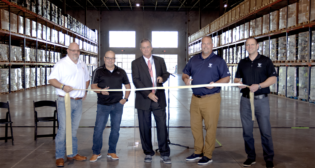 Celebrating the launch of Watco Logistics’ warehouse and logistics operating center in Springdale, Ark., were (left to right) Andy Moran, Watco Senior Director of Retail Services; Eric Wolfe, Watco Logistics President; Doug Sprouse, Springdale Mayor; Dan Smith, Watco CEO; and Nick Coomes, Watco Executive Vice President and Chief Operating Officer. (Watco Photograph)