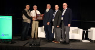 Left to right: Iowa Traction Railway Roadmaster Mike Rumeliote, former Iowa Traction Railway owner Dave Johnson, National Railway Historical Society representative Mike Yuhas, Railway Age Editor-in-Chief William C. Vantuono, Railway Track & Structures Editor-in-Chief David C. Lester.