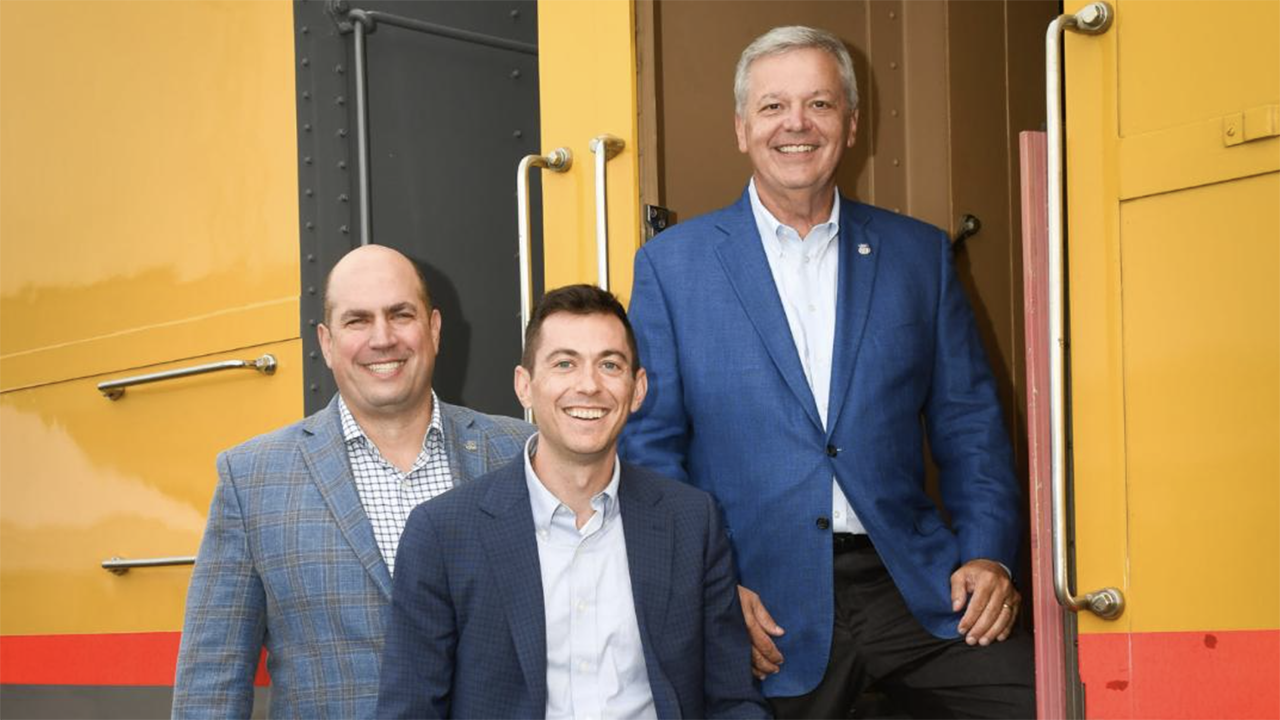 Standing next to one of the railcars in Union Pacific’s Heritage Fleet, from left are External Affairs team members Wes Lujan, Andrew Brady and Printz Bolin. (Caption and Photograph Courtesy of UP)