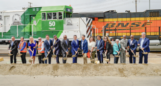 Federal, state, city and Port of Long Beach officials on July 18 celebrated the groundbreaking for the $1.57 billion Pier B On-Dock Rail Support Facility project. Pictured from left are Dr. Noel Hacegaba, Port of Long Beach Chief Operating Officer; Long Beach Harbor Commissioner Sharon L. Weissman; Long Beach Councilmember Kristina Duggan, 3rd District; Long Beach Councilmember Roberto Uranga, 7th District; Mark Tollefson, Undersecretary, California State Transportation Agency; Long Beach Harbor Commission President Bobby Olvera Jr.; Long Beach Mayor Rex Richardson; U.S. Transportation Secretary Pete Buttigieg; U.S. Rep. Dr. Robert Garcia, California 42nd District; Long Beach Councilmember Megan Kerr, 5th District; Port of Long Beach CEO Mario Cordero; Patricia Aguirre, Board Secretary, International Longshore and Warehouse Union Local 63; Long Beach Harbor Commission Vice President Bonnie Lowenthal; Long Beach Harbor Commissioner Steven Neal; Long Beach Councilmember Al Austin, 8th District; and Los Angeles City Councilmember Tim McOsker, 15th District. (Caption and Photograph Courtesy of POLB)