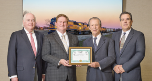 Tarantula Corporation said its TEXC acquisition was made possible due to the efforts of Bill Wood, Director of Contracts (pictured far right); Robert Ginsburg, Director, McDonald Sanders, P. C. (far left); and Kevin Sheys of Rail Regulatory Law, who helped secured the Surface Transportation Board exemption. Also pictured (left to right, after Sanders): Kevin Erasmus, President and CEO of Davoil, Inc. and Fort Worth & Western Railroad Company, and William Davis Sr., Chairman of the Board. (Tarantula Corporation Photograph)