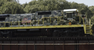 “Today, we are excited to share this video which introduces our new locomotive design scheme honoring veterans and service members, and showcases several of the many veterans who work for G&W,” G&W posted on Facebook and LinkedIn on Veterans Day. (Screenshot of Providence & Worcester 4069 from G&W Video)