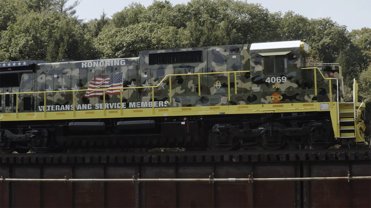 “Today, we are excited to share this video which introduces our new locomotive design scheme honoring veterans and service members, and showcases several of the many veterans who work for G&W,” G&W posted on Facebook and LinkedIn on Veterans Day. (Screenshot of Providence & Worcester 4069 from G&W Video)