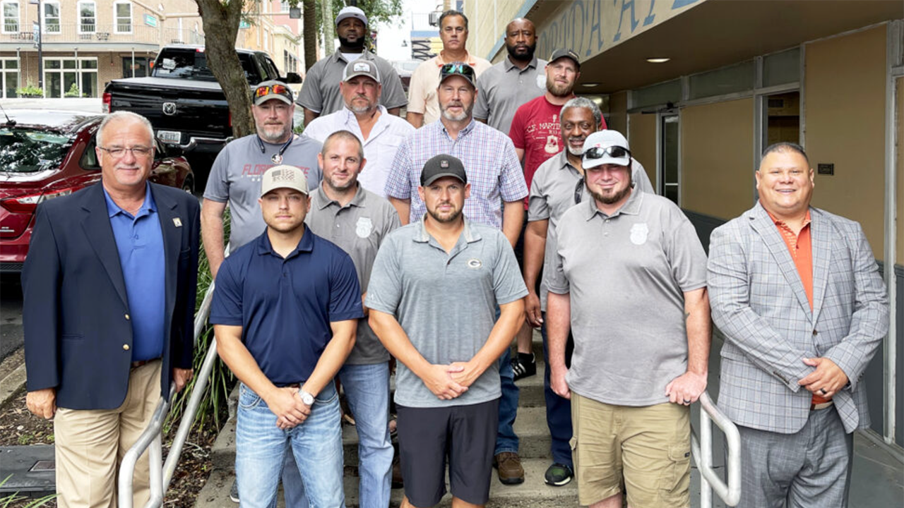 BLET Vice President Randy Fannon (far left) and BLET Special Representative Jorge Gomez (far right) with newly organized members from Florida Gulf & Atlantic in 2023. (Caption and Photograph Courtesy of BLET)