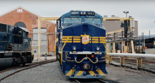 Norfolk Southern’s team at the Juniata Locomotive Paint Shop in Altoona, Pa., brought predecessor railroad TAG “back to life.” (Screen grab from NS video)