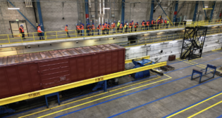 Overview of the refreshed Simuloader (SMU) being showcased to a breakout tour group during the 2024 TTC Conference & Tour. (TTC Operated by ENSCO Photograph)