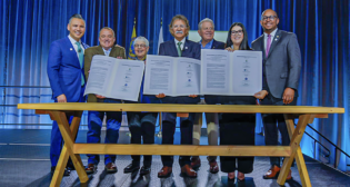 At the conclusion of POLB’s State of the Port address earlier this month, officials signed a memorandum of understanding to collaborate on offshore wind power projects. Pictured, from left to right: Port of Long Beach COO Dr. Noel Hacegaba, Port of Humboldt Bay Executive Director Chris Mikkelsen, Long Beach Harbor Commission President Bonnie Lowenthal, Port of Long Beach CEO Mario Cordero, Long Beach Harbor Commission Vice President Frank Colonna, State Lands Commission Senior Mineral Resources Engineer Vanessa Perez, and Long Beach Mayor Rex Richardson. (POLB Photograph)