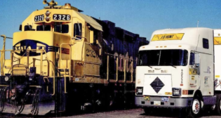 ATSF President Mike Haverty “saw the potential to harness the cost-efficiency of rail transportation with the agility of highway trucking,” JBHT reported. “He invited Mr. Hunt to join him on a train ride to discuss his idea on November 1, 1989 … By the end of their journey, they’d formed an agreement to put J.B. Hunt trailers on the steel highway. A simple handshake marked the beginning of a decades-long strategic alliance that would change the industry forever.” (JBHT Photograph)