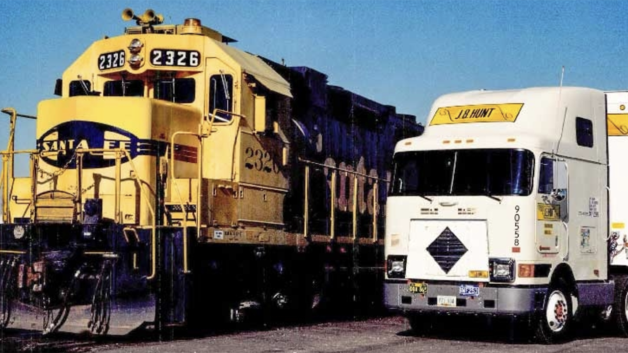 ATSF President Mike Haverty “saw the potential to harness the cost-efficiency of rail transportation with the agility of highway trucking,” JBHT reported. “He invited Mr. Hunt to join him on a train ride to discuss his idea on November 1, 1989 … By the end of their journey, they’d formed an agreement to put J.B. Hunt trailers on the steel highway. A simple handshake marked the beginning of a decades-long strategic alliance that would change the industry forever.” (JBHT Photograph)
