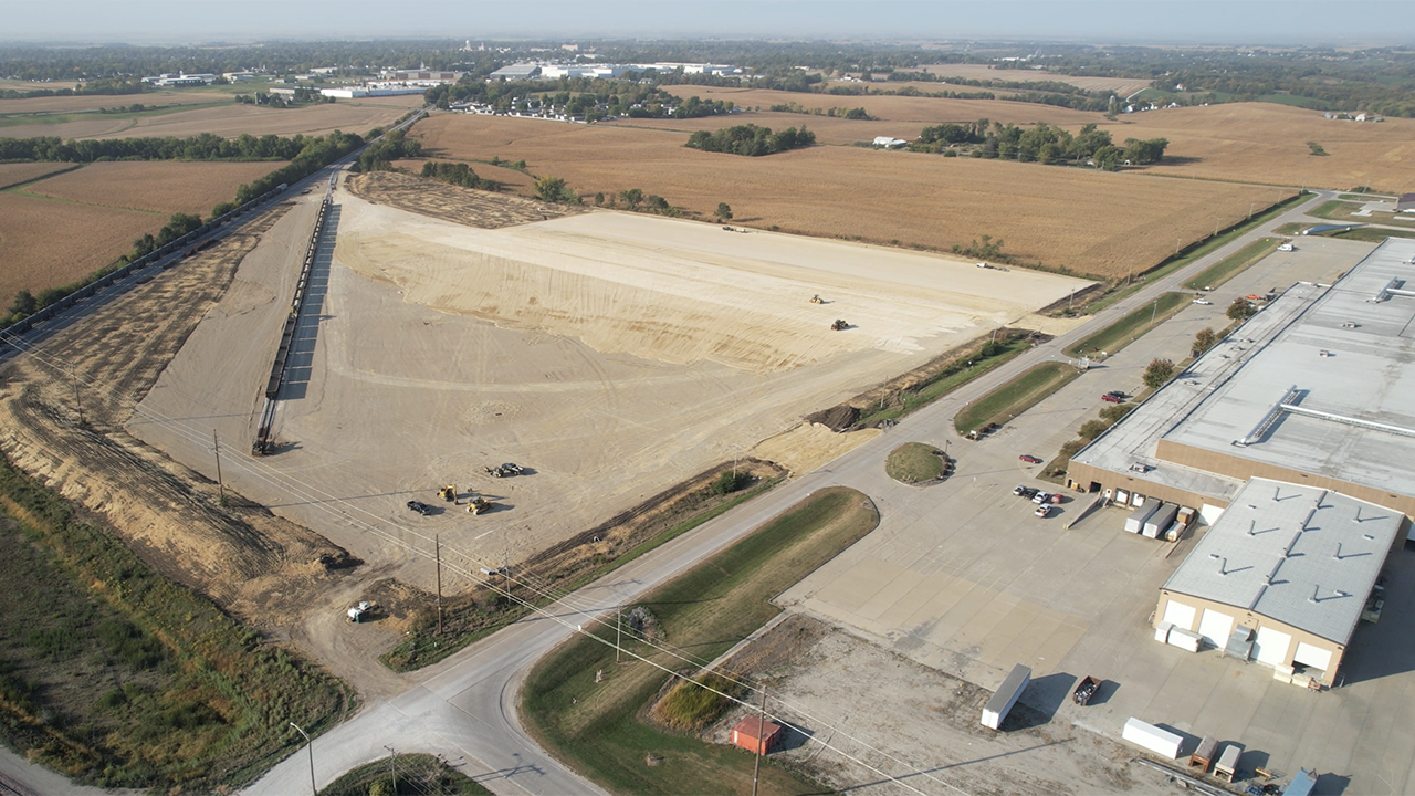 This drone image shows the site of Iowa Interstate Railroad's wind energy component transload facility in Newton, Iowa, while it was under construction. Directly adjacent to the facility is TPI Composites, a wind turbine blade manufacturer. (Caption and Photograph Courtesy of ASLRRA)