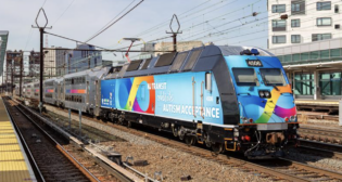 NJT rolled out specially wrapped vehicles, including a locomotive (pictured), for Autism Acceptance Month. (NJT Photograph)