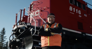 Darryl Perry, a CPKC locomotive engineer in Sparwood, B.C., Canada, is one of the 200-plus “CPKC Hypermilers” who the railroad said “use their ‘feel’ for a locomotive and in-depth local knowledge, coupled with fuel-efficient strategies, to operate trains safely while reducing excess fuel burn.” (Screen Grab from CPKC Video)