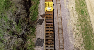 UP’s automated cross tie unloading equipment in action in North Little Rock, Ark. (UP Photograph)