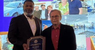Pacific Harbor Line and President Otis L. Cliatt II (left) received the 2025 Maritime Industry Salute Award on Oct. 2. It was presented by Guy Fox, Chairman of the Board of the International Seafarers Center of the Ports of Long Beach and Los Angeles (right). (Photograph Courtesy of PHL)