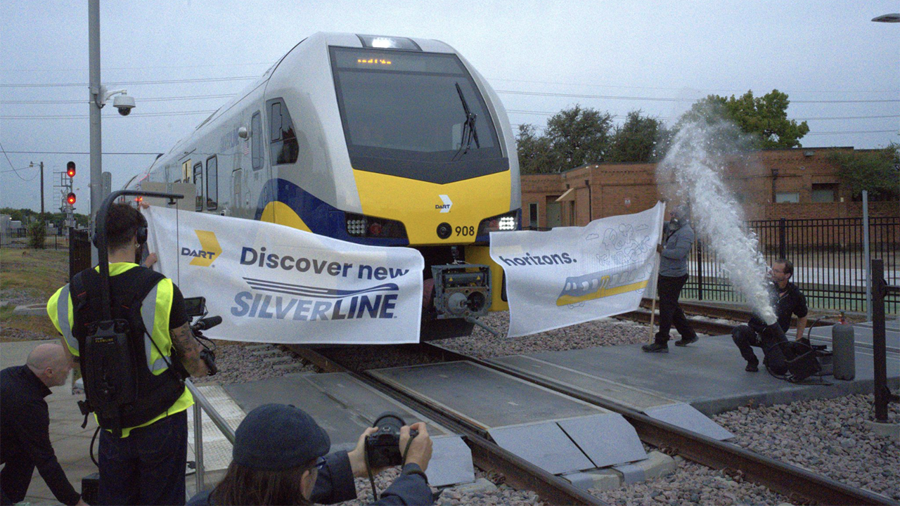 “Built in our Salt Lake City facility, these trains are designed for comfort, accessibility, and sustainability,” Stadler, the manufacturer of the Silver Line’s eight DMUs reported via LinkedIn. “With seating for 230 passengers, standing room for 100, and compliance with EPA Tier 4 emissions standards, they’re ready to serve the region with quiet, efficient, and modern mobility. 🛤️ The Silver Line spans 26 miles, connecting seven cities and DFW Airport. To everyone who helped bring this vision to life: thank you. We’re honored to be part of this journey.” (Photograph Courtesy of Stadler)