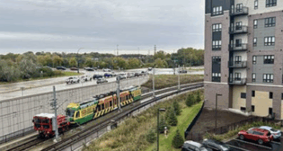 The first light rail train is pulled along the Green Line Extension near the Southwest Station in Eden Prairie, Minn., to test the tracks the entire length of the line. (Caption and Photograph Courtesy of Metro Transit)