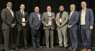 At ASLRRA’s recent Central and Pacific Region Meeting, which included more than 300 attendees, ASLRRA Executive Board Members Otis L. Cliatt II (pictured, left; VP, Pacific Region) and Matthew O. Walsh (second from right; Chair) and ASLRRA President Chuck Baker (right) presented the Belt Railway Company of Chicago with the President’s Award in the “More than 500,000 Person-Hours Worked” category. Accepting the safety award were Junior Software Developer Mason Myre, Assistant Chief Mechanical Officer Robert Perham, Superintendent Jason Charbonneau and Manager of Signals Jorge Guerrero (second through fifth from left, respectively). (Photograph Courtesy of ASLRRA)
