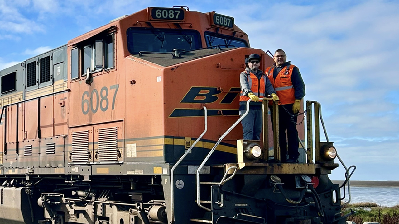 Pictured are BNSF Locomotive Engineer Buddy Hall (right) and Conductor Ioannis Kalogiros on the first train to operate in Canada under Positive Train Control (PTC) protection. (BNSF Photograph)