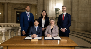 Pictured Standing (Left to Right): Jamie Moses, Minister of Business, Mining, Trade and Job Creation for the Province of Manitoba; Rebecca Chartrand, Minister of Northern and Arctic Affairs and Minister responsible for the Canadian Northern Economic Development Agency; and Nick Hays, President and CEO of the Winnipeg Airports Authority. Pictured Sitting (Left to Right): Chris Avery, President and CEO of the Arctic Gateway Group; and Carly Edmundson, President and CEO of CentrePort Canada. (Courtesy AGG)