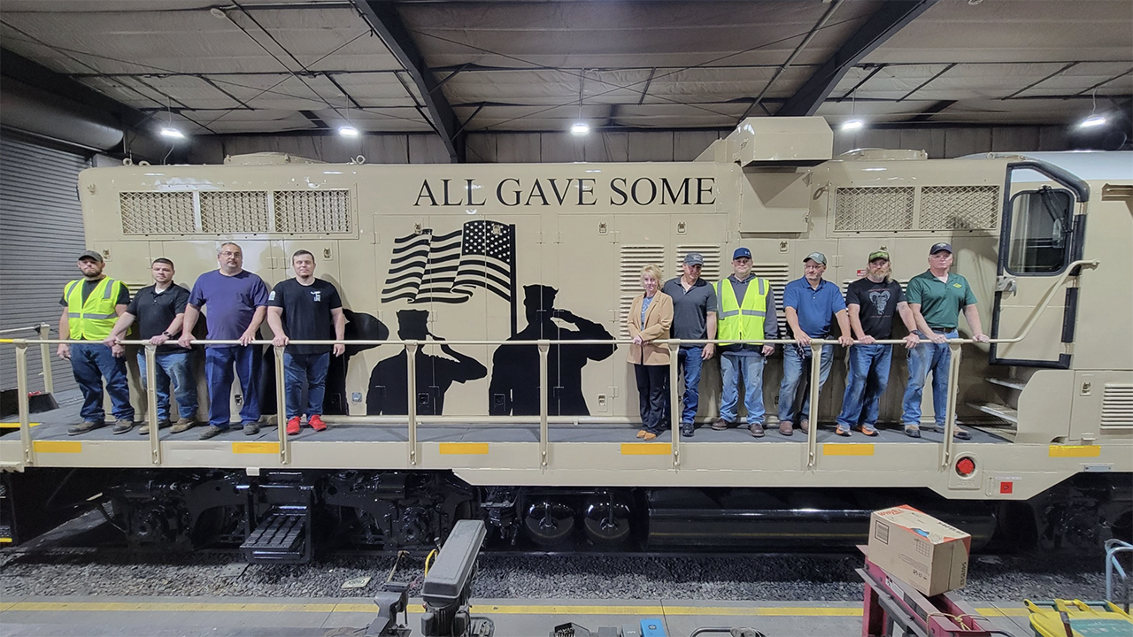 North Shore Railroad’s military veteran employees pictured with the company’s Veterans Unit, LVRR 9052. The locomotive was dedicated to this group, and each person signed an interior board that was sealed to remain on permanent display. (NSR Photograph, Courtesy of ASLRRA)