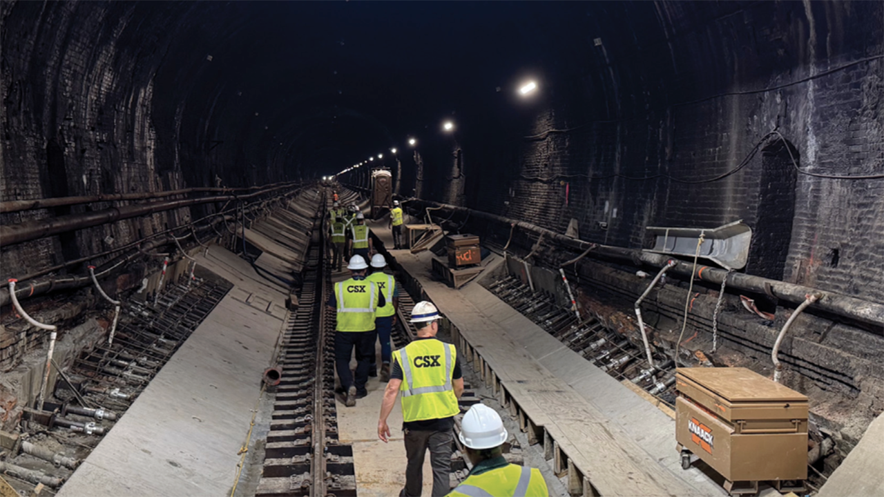 CSX’s 2025 Annual Report highlighted its reopening of Baltimore’s Howard Street Tunnel after a $450 million expansion (work pictured above) that cleared a long-standing bottleneck on the I-95 corridor and will enable double-stack intermodal service through Baltimore once remaining clearance work is completed in early 2026. (Courtesy of CSX)